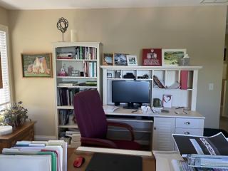 Original photograph of the existing white desk and bookshelves with computer monitor, purple chair and office storage